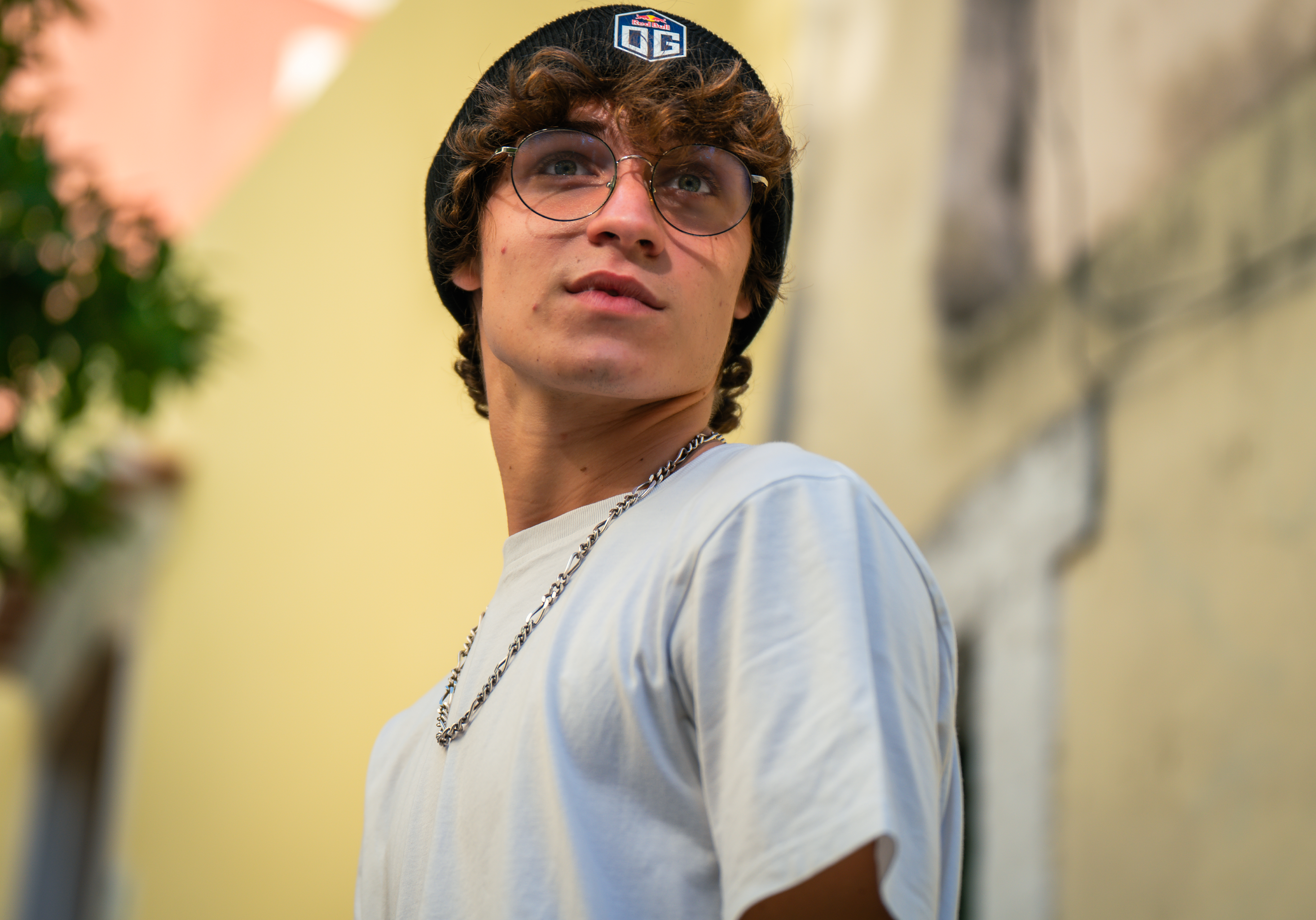 A male model wearing a dark blue beanie featuring the OG logo at the front and New Era logo on the side