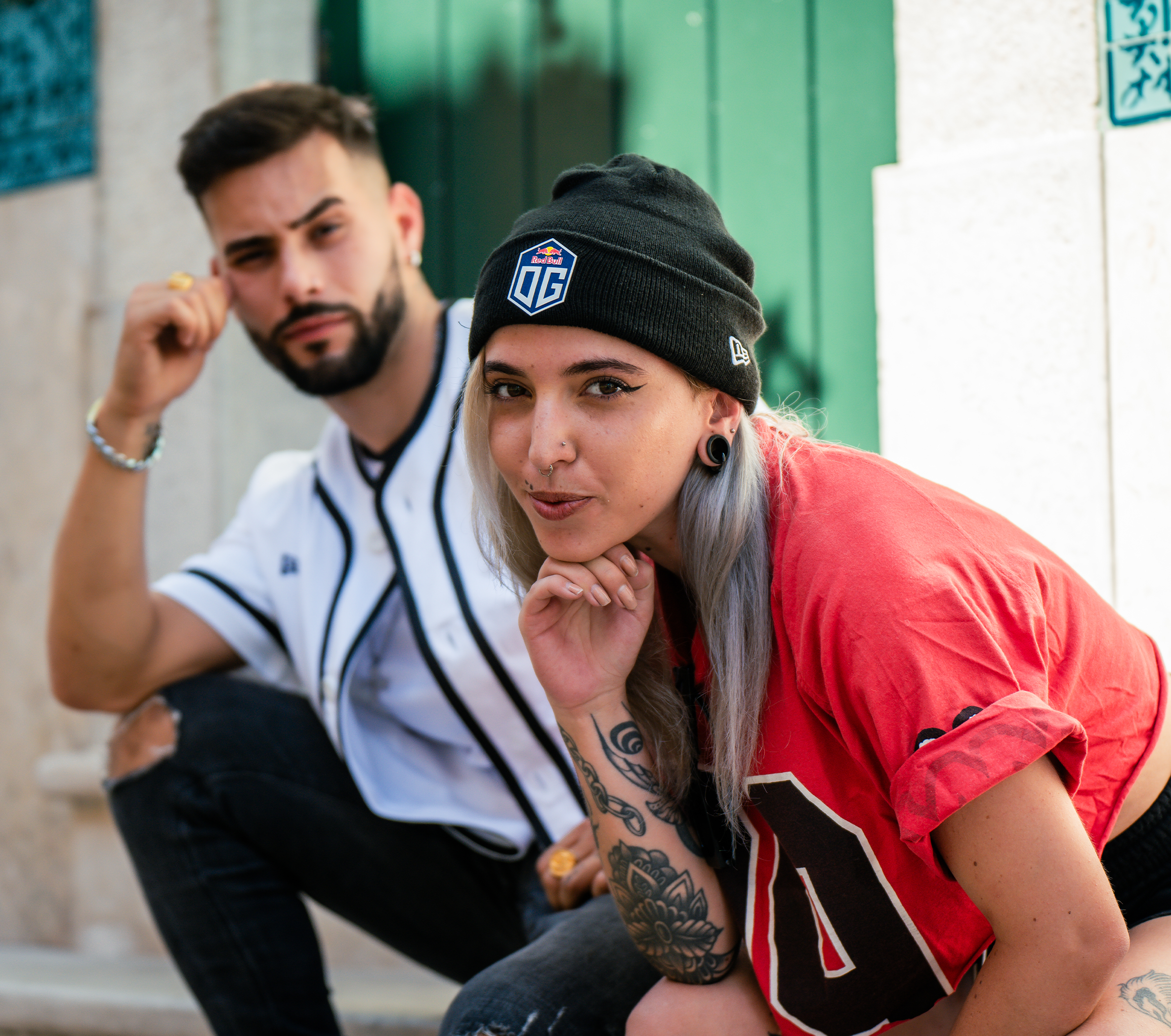 A female model wearing a dark blue beanie featuring the OG logo at the front and New Era logo on the side.