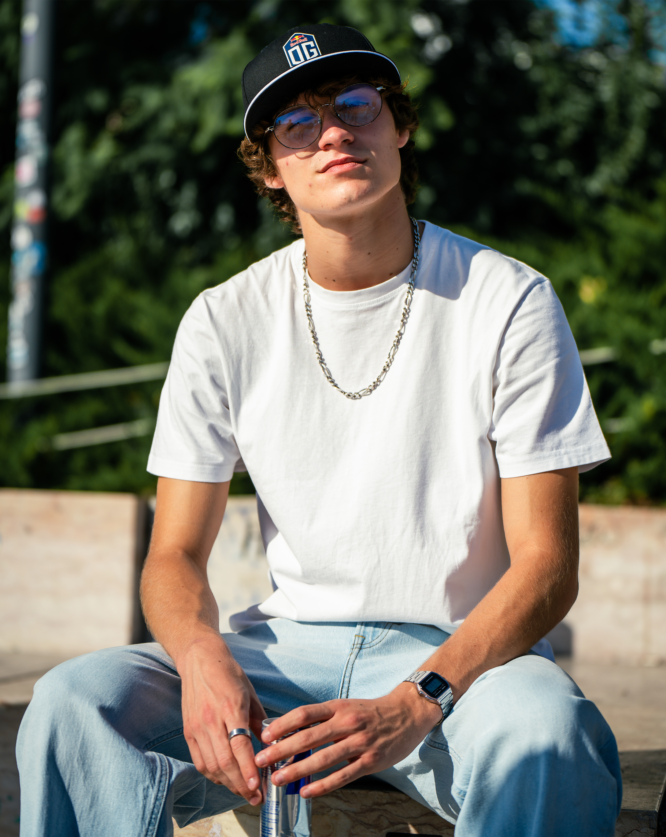 Model wearing a dark blue snapback cap with the OG logo on the front and the New Era logo on the side.