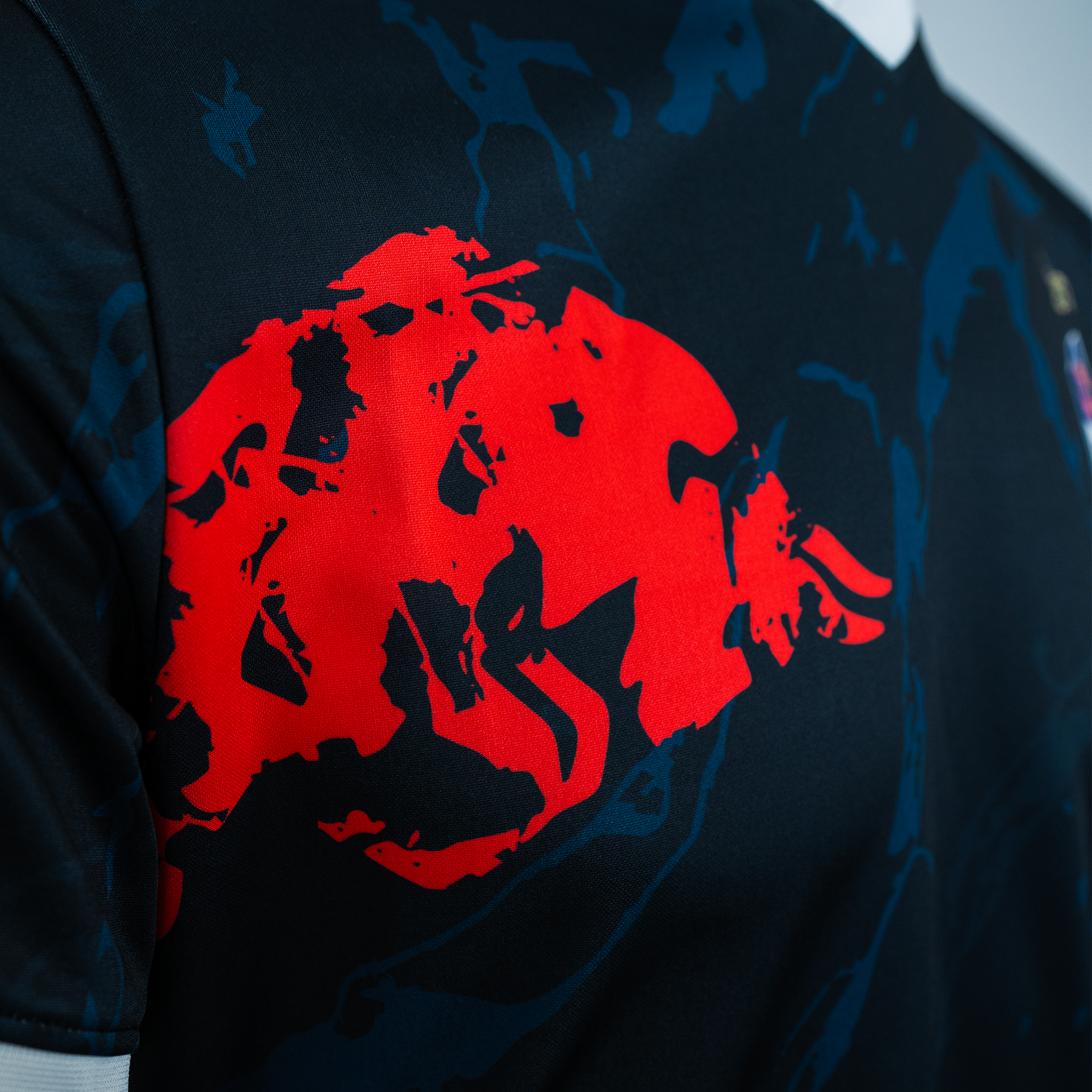 Close-up view of the right side of the jersey featuring the Red Bull logo.