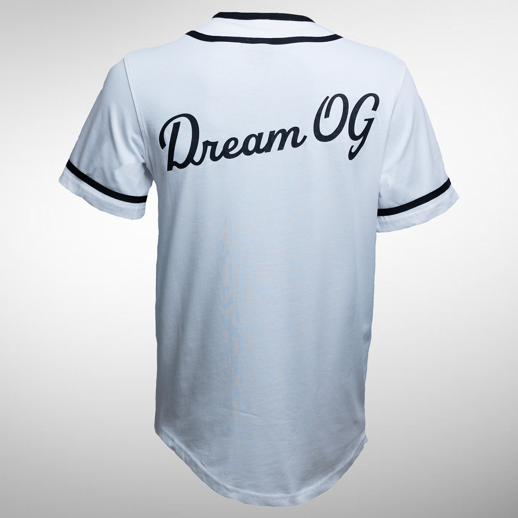 The back of a black and white baseball tee featuring the slogan "Dream OG" in large, bold, white letters, with a plain background highlighting the design.